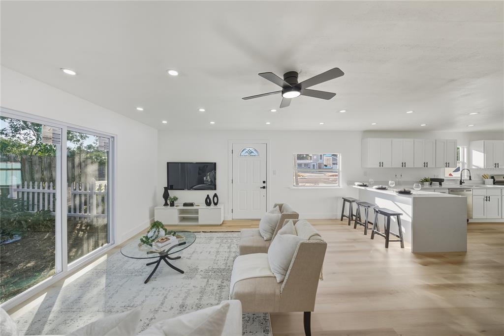 542 64th Street South St. Petersburg, FL 33707 - Photo 3 of 49 a living room with furniture and a flat screen tv