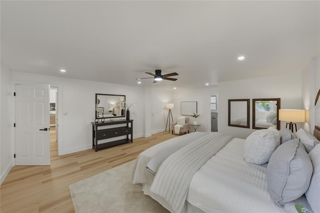 542 64th Street South St. Petersburg, FL 33707 - Photo 31 of 53 a spacious bedroom with a bed and a chandelier