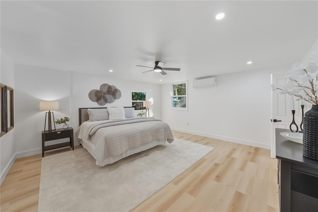 542 64th Street South St. Petersburg, FL 33707 - Photo 31 of 49 a bedroom with a large bed and a chandelier