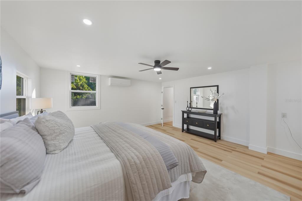542 64th Street South St. Petersburg, FL 33707 - Photo 32 of 49 a bedroom with a bed and a chandelier