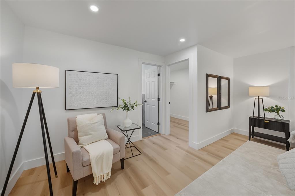 542 64th Street South St. Petersburg, FL 33707 - Photo 35 of 53 a spacious bedroom with a bed and a lamp