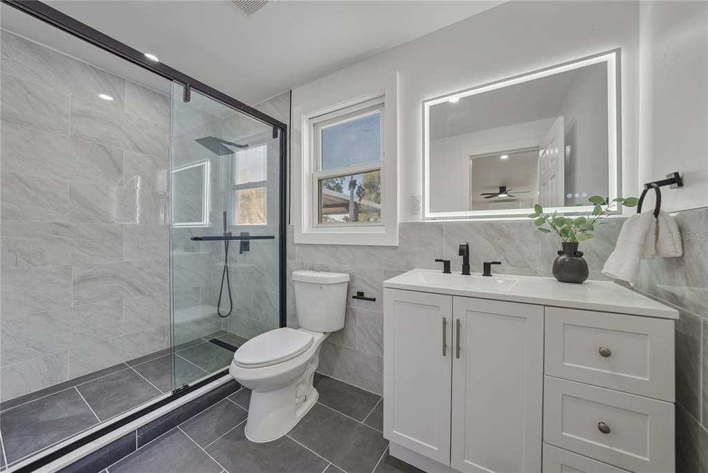 542 64th Street South St. Petersburg, FL 33707 - Photo 37 of 53 a bathroom with a sink a toilet and shower