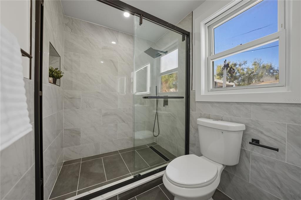 542 64th Street South St. Petersburg, FL 33707 - Photo 38 of 53 a white toilet sitting next to a bathroom sink