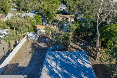 a view of a backyard with wooden fence