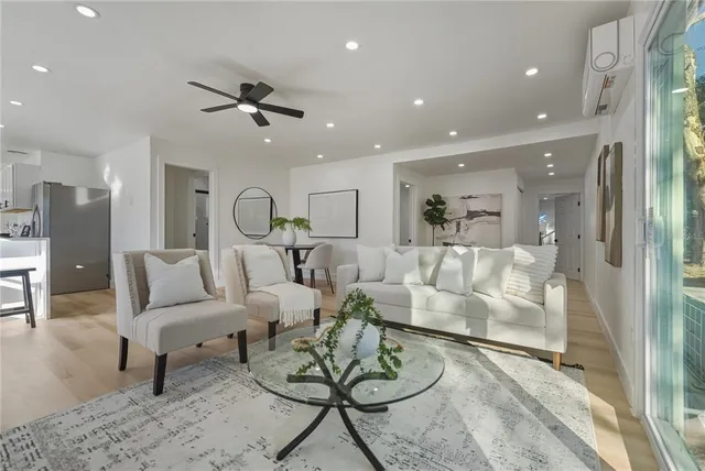 a living room with furniture and kitchen view