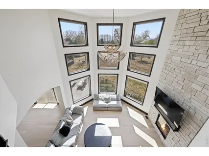 a living room with furniture and a floor to ceiling window