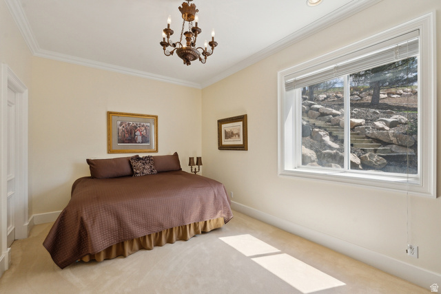 1714 Ridge Point Drive Bountiful, UT 84010 - Photo 88 of 132 Traditional chandelier lighting, recessed ceiling lighting, crown molding, white trim, and a window with a rock garden backdrop