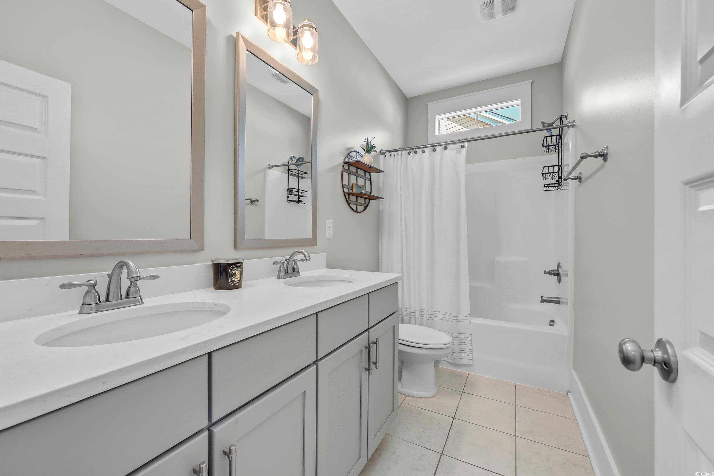 3005 Purity Place Loop Murrells Inlet, SC 29576 - Photo 23 of 36 Bathroom with double vanity, tile patterned floori