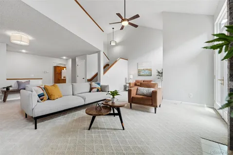 a living room with furniture and a potted plant