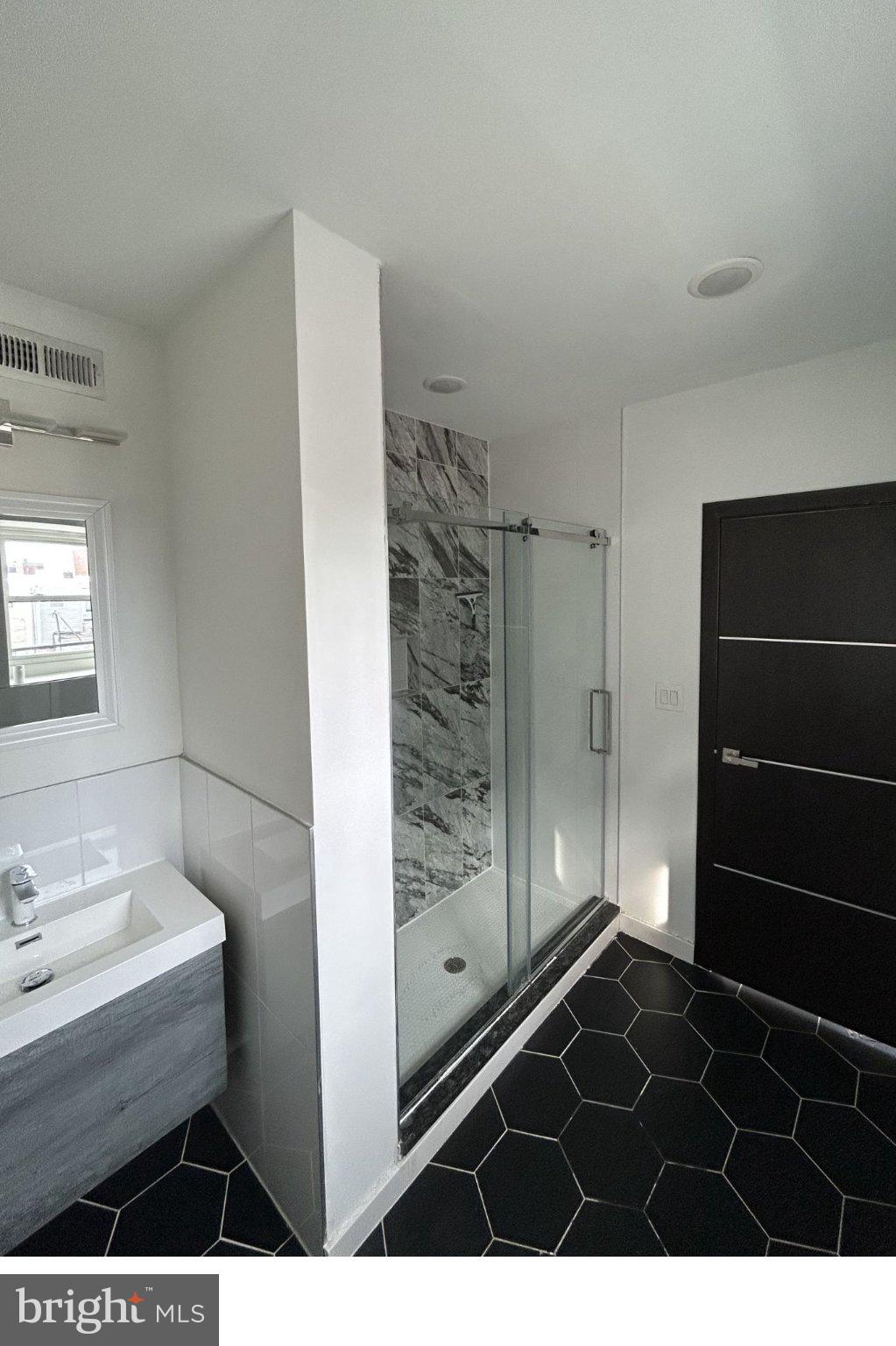 1713 South 2nd Street, Unit B Philadelphia, PA 19148 - Photo 14 of 15 Sleek modern bathroom with elegant tiles.