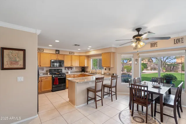 a large kitchen with a table and chairs