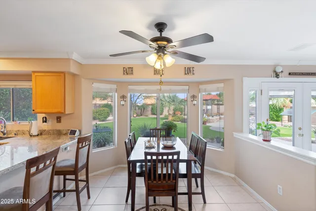 a dining room with furniture a chandelier and a rug