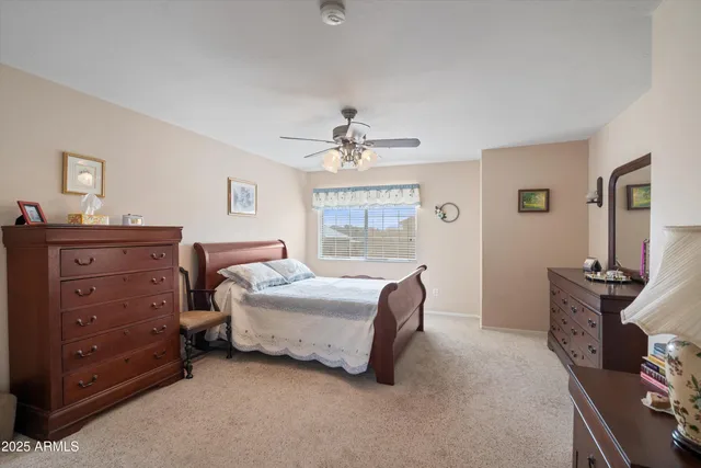 a view of a livingroom with furniture and a ceiling fan