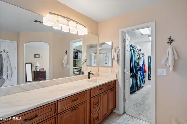 a bedroom with bed and a chandelier