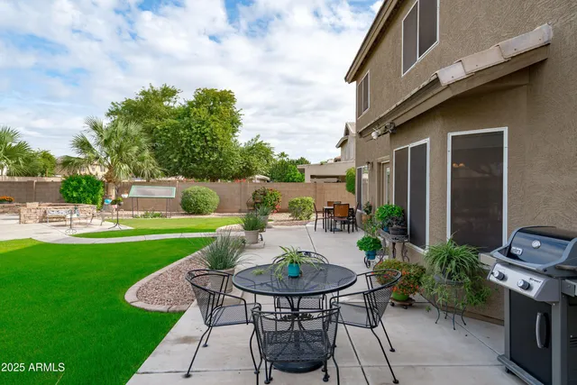 a view of a backyard with sitting area