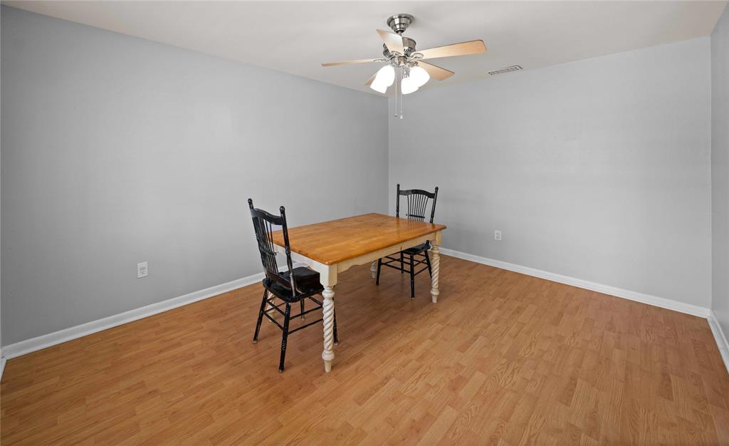6155 Kathy Drive Murchison, TX 75778 - Photo 11 of 26 a view of a dining room with furniture and wooden floor