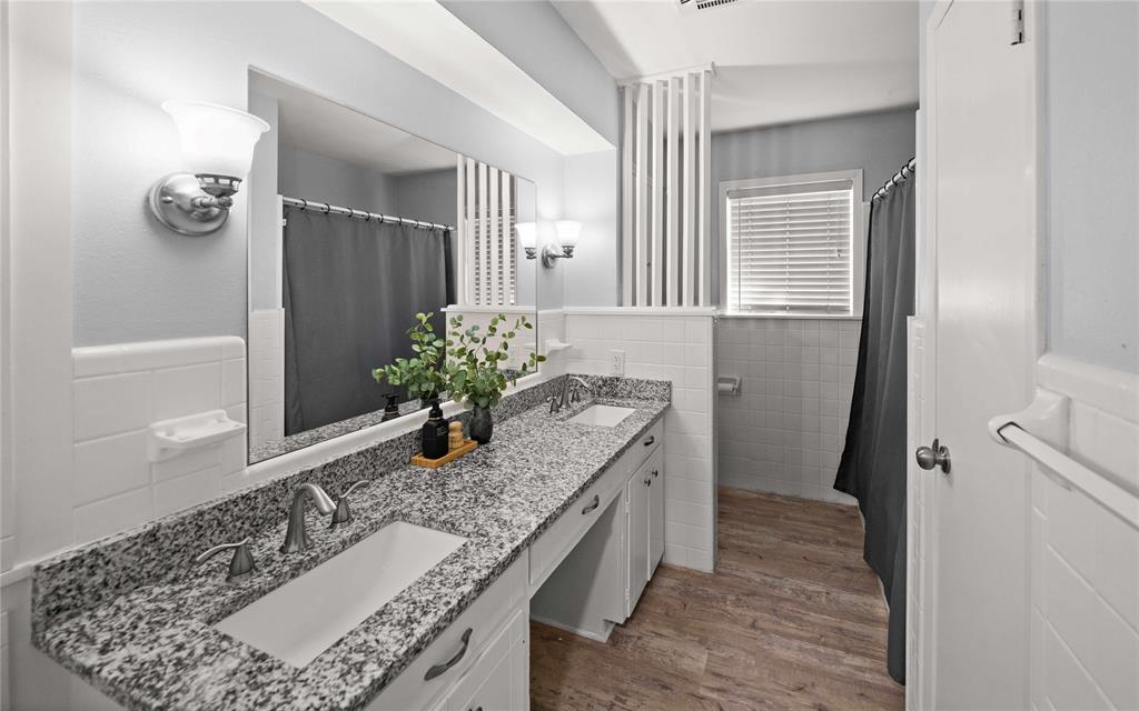 6155 Kathy Drive Murchison, TX 75778 - Photo 13 of 26 a bathroom with a granite countertop sink a toilet and mirror