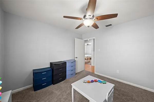 a room with a dresser and a window