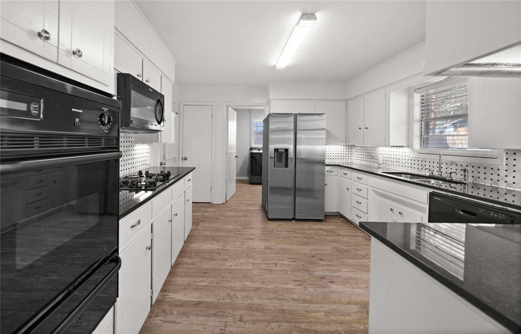 6155 Kathy Drive Murchison, TX 75778 - Photo 5 of 26 a large kitchen with stainless steel appliances kitchen island granite countertop a stove a sink and a refrigerator