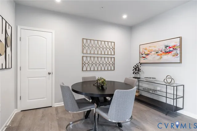 a view of a dining room with furniture and wooden floor