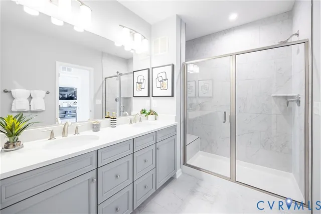 a bathroom with a shower sink and mirror