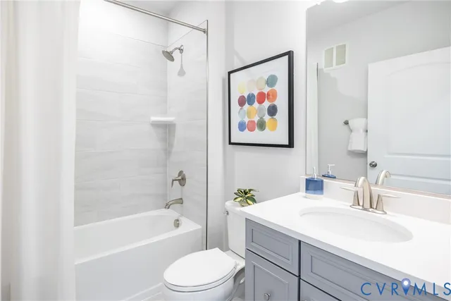 a bath room with a toilet a sink and a bath tub