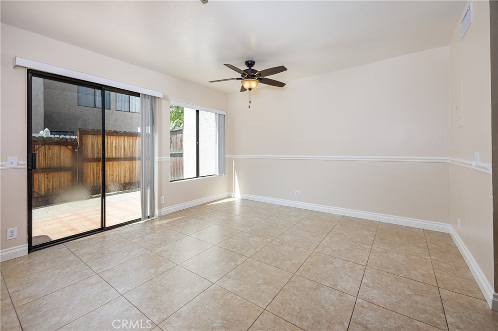 25885 Trabuco Road, Unit 206 Lake Forest, CA 92630 - Photo 13 of 40 an empty room with chandelier fan and windows