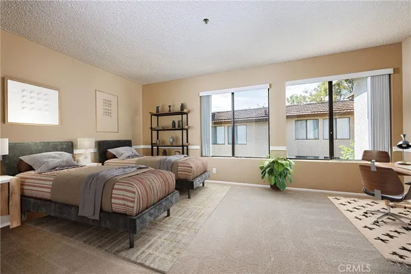 a spacious bedroom with a bed and a couch