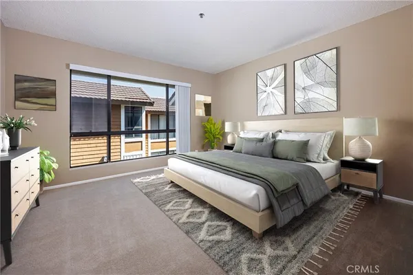 a bedroom with a balcony a bed and a couch