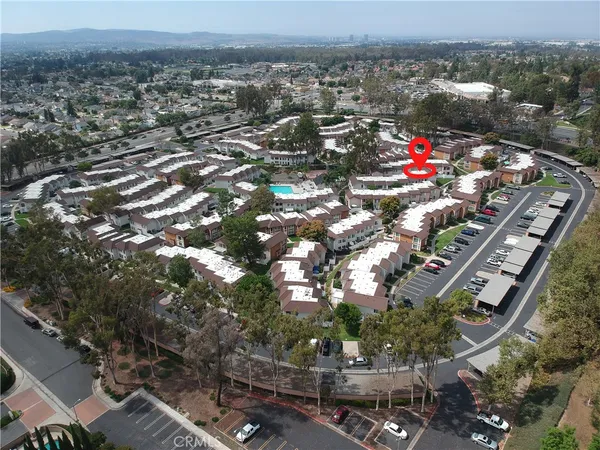 an aerial view of a house with a yard and lake view