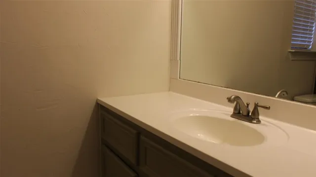 a white toilet sitting next to a bathroom sink