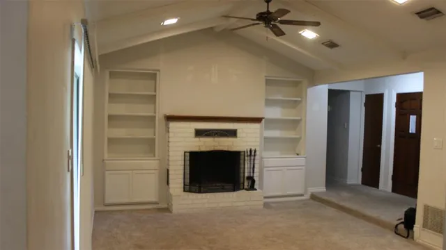 a view of an empty room with a fireplace