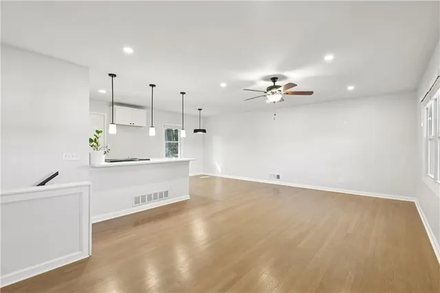 a view of a kitchen with a sink stainless steel appliances and cabinets