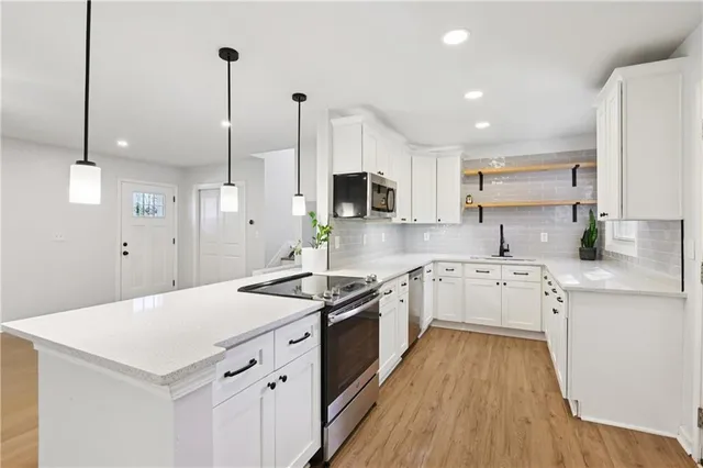 a kitchen with a sink stove and refrigerator