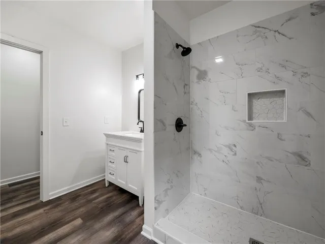a bathroom with a bathtub sink and mirror
