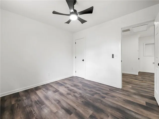 an empty room with fan and a ceiling fan