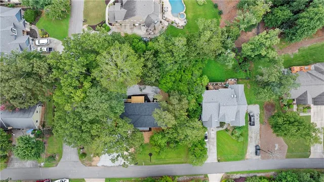 an aerial view of a house with yard and outdoor seating