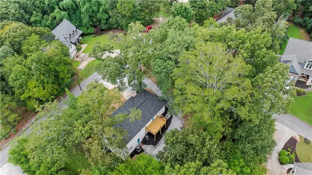 an aerial view of a house with a yard and outdoor seating