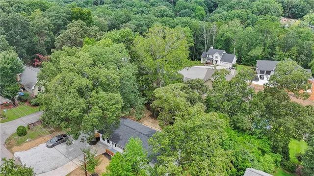 an aerial view of a houses with a lake view
