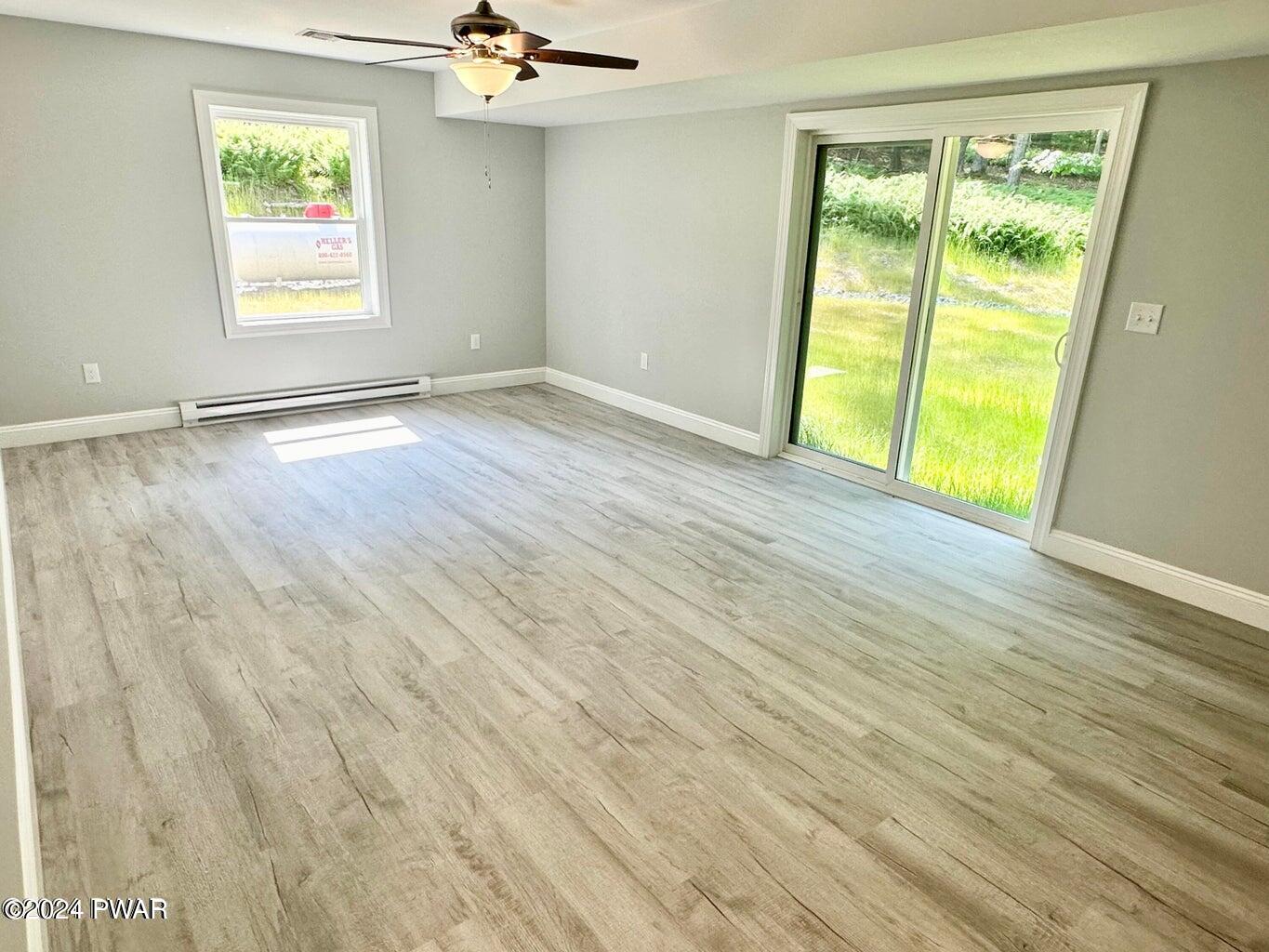 123 R Rhododendron Lane Milford, PA 18337 - Photo 24 of 29 a view of an empty room with a window and wooden floor