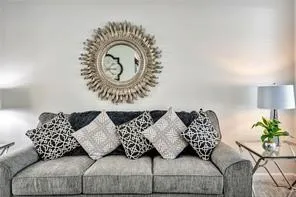 a living room with furniture and a potted plant