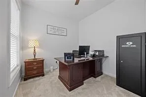 a view of a workspace with furniture and a window