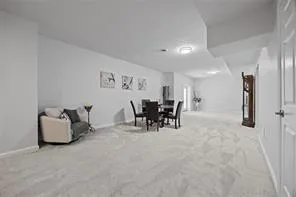 a dining room with furniture and a chandelier