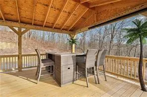a view of a patio with table and chairs with wooden floor and fence