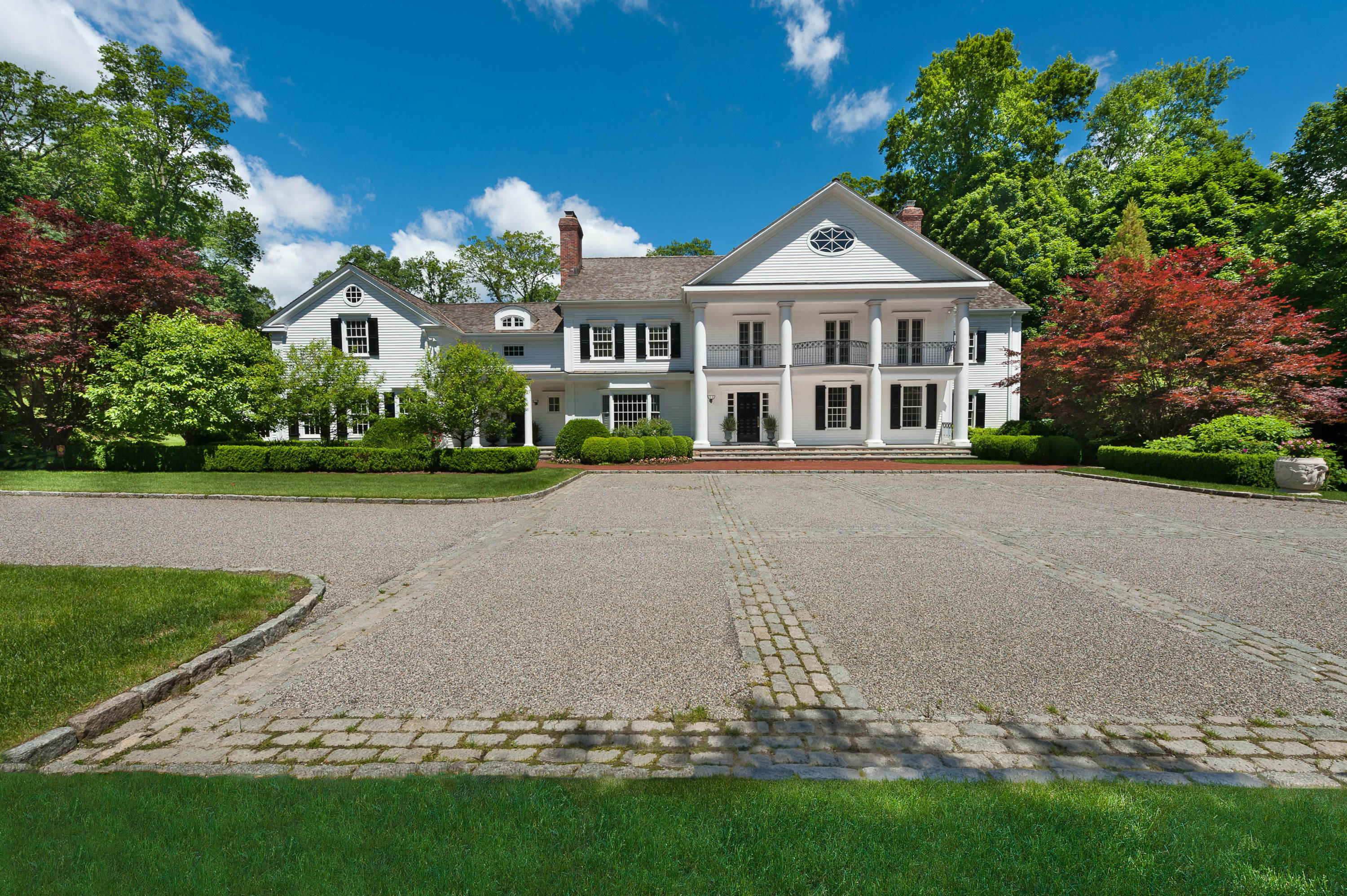 399 Wahackme Road New Canaan, CT 06840 - Photo 1 of 35 a front view of a house with a garden