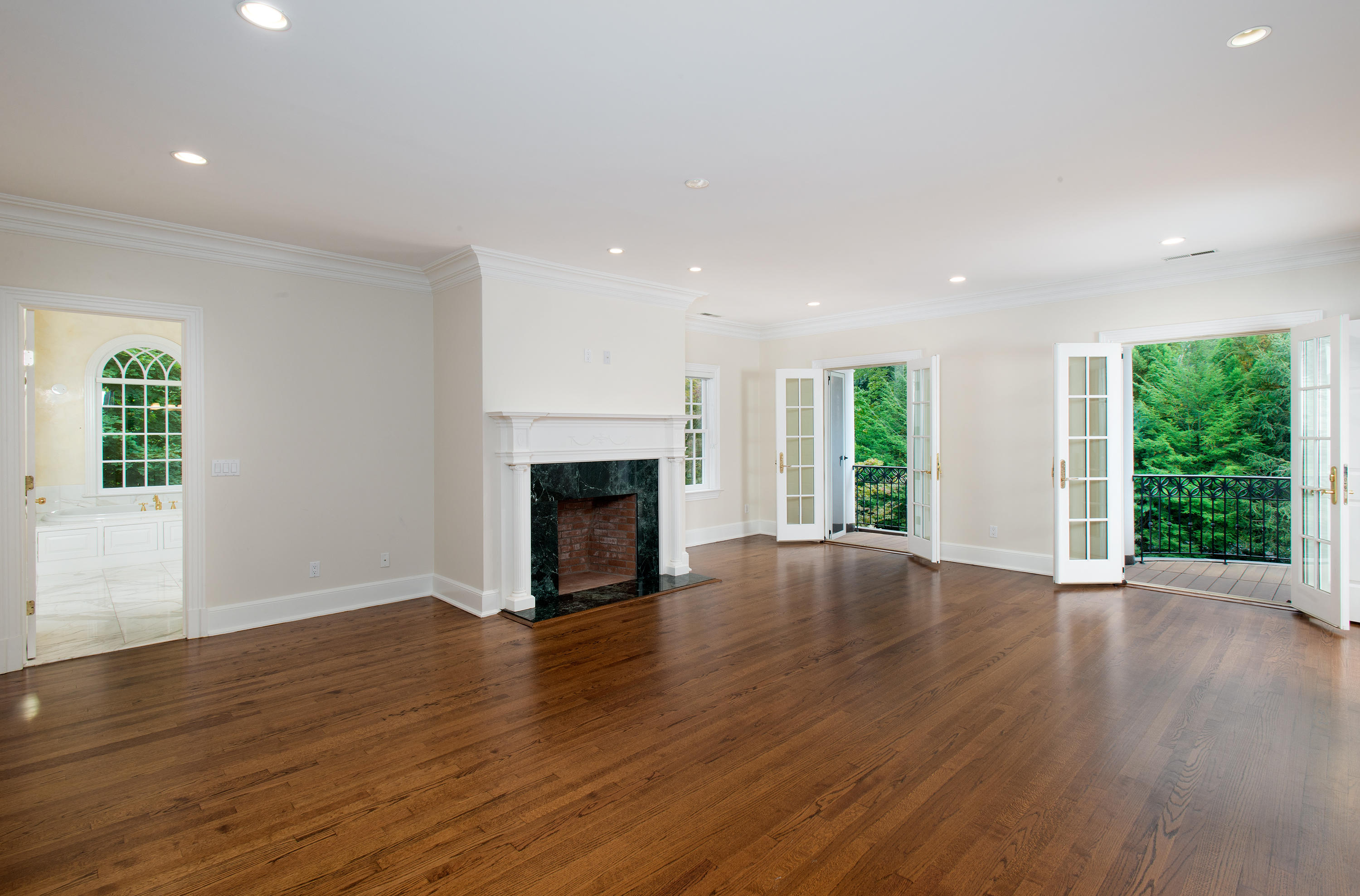 399 Wahackme Road New Canaan, CT 06840 - Photo 18 of 35 a view of an empty room with wooden floor and a window