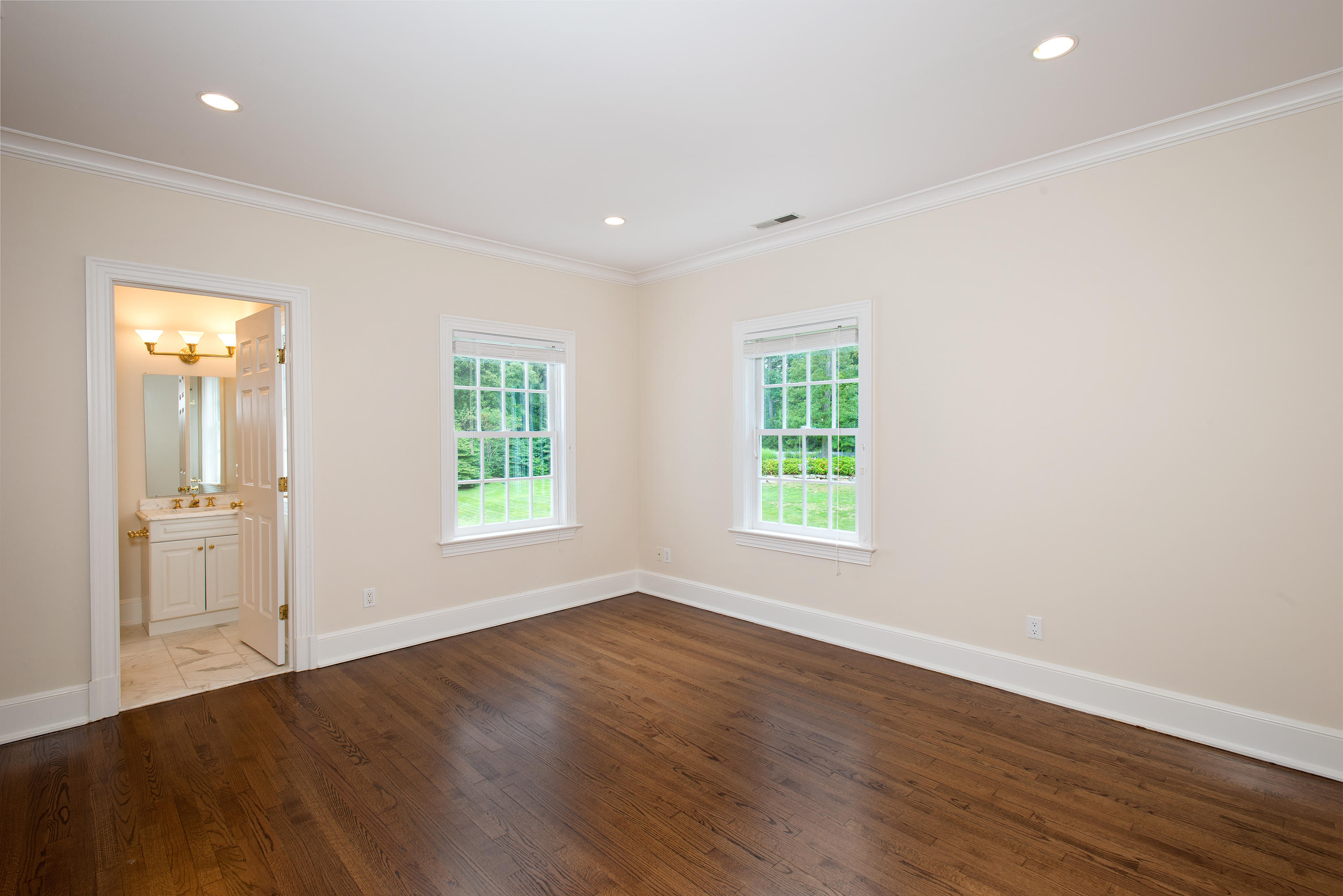 399 Wahackme Road New Canaan, CT 06840 - Photo 21 of 35 a view of an empty room with wooden floor and a window