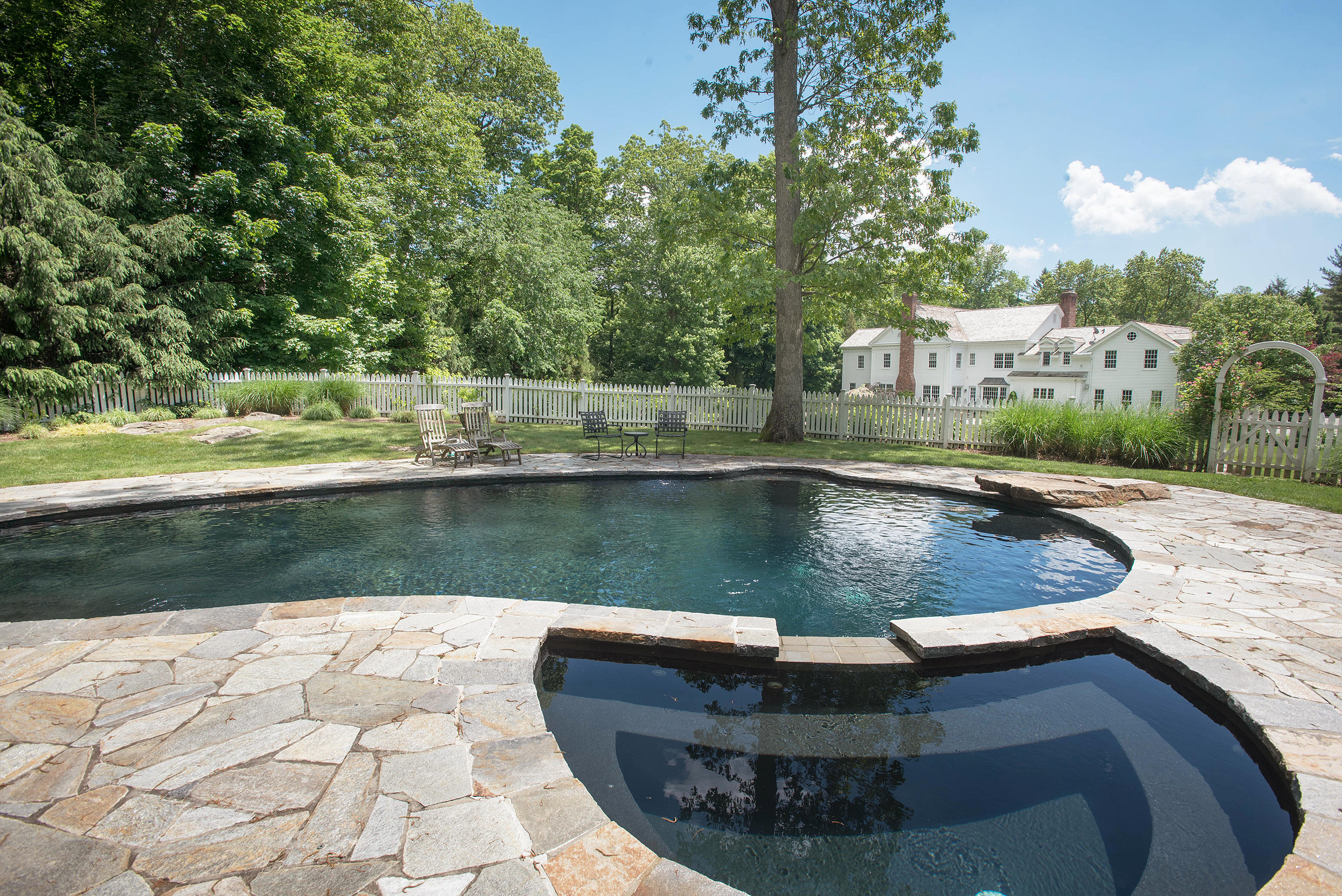 399 Wahackme Road New Canaan, CT 06840 - Photo 25 of 35 a view of a house with a yard