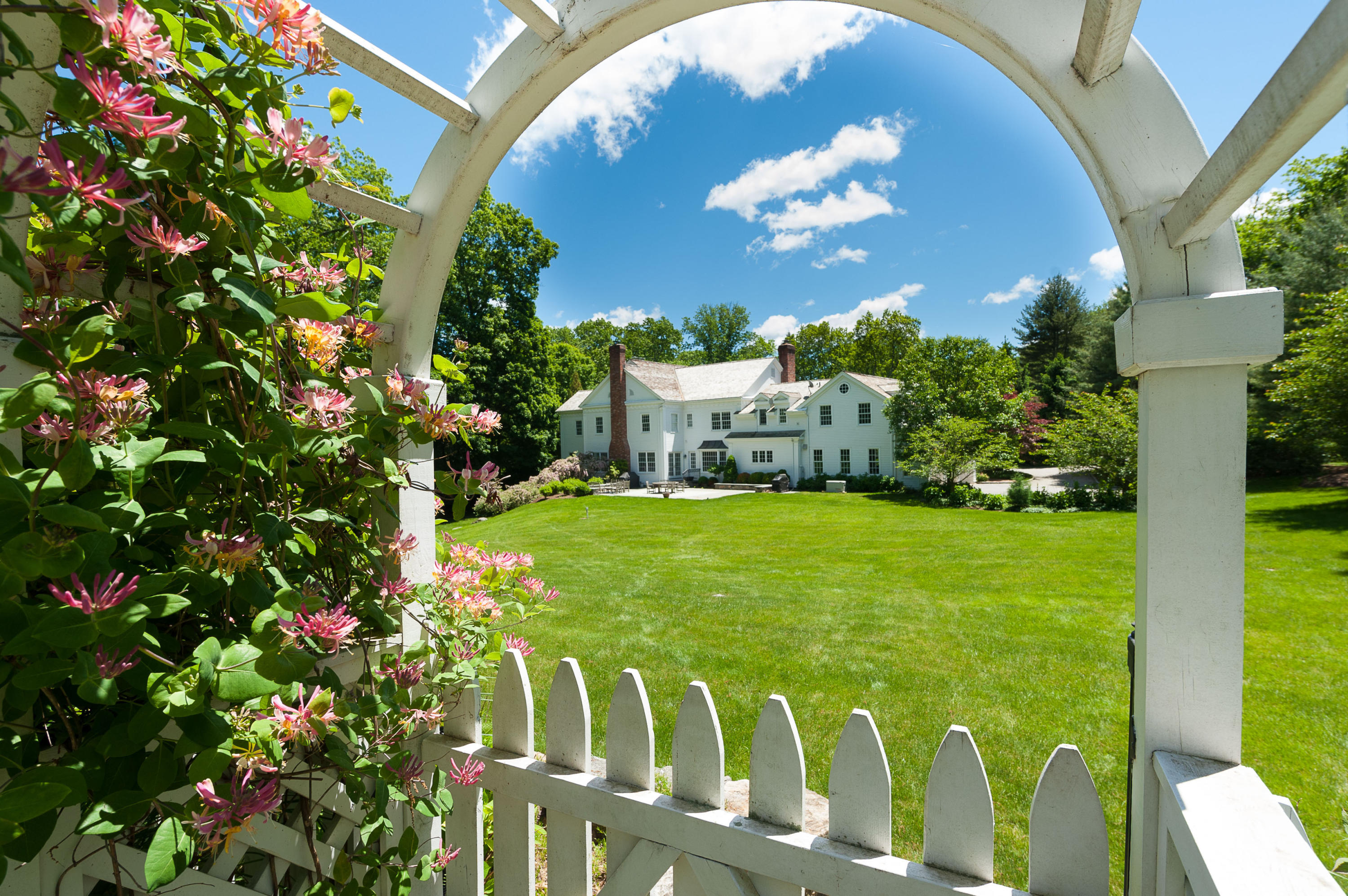 399 Wahackme Road New Canaan, CT 06840 - Photo 26 of 35 a front view of a house with a garden