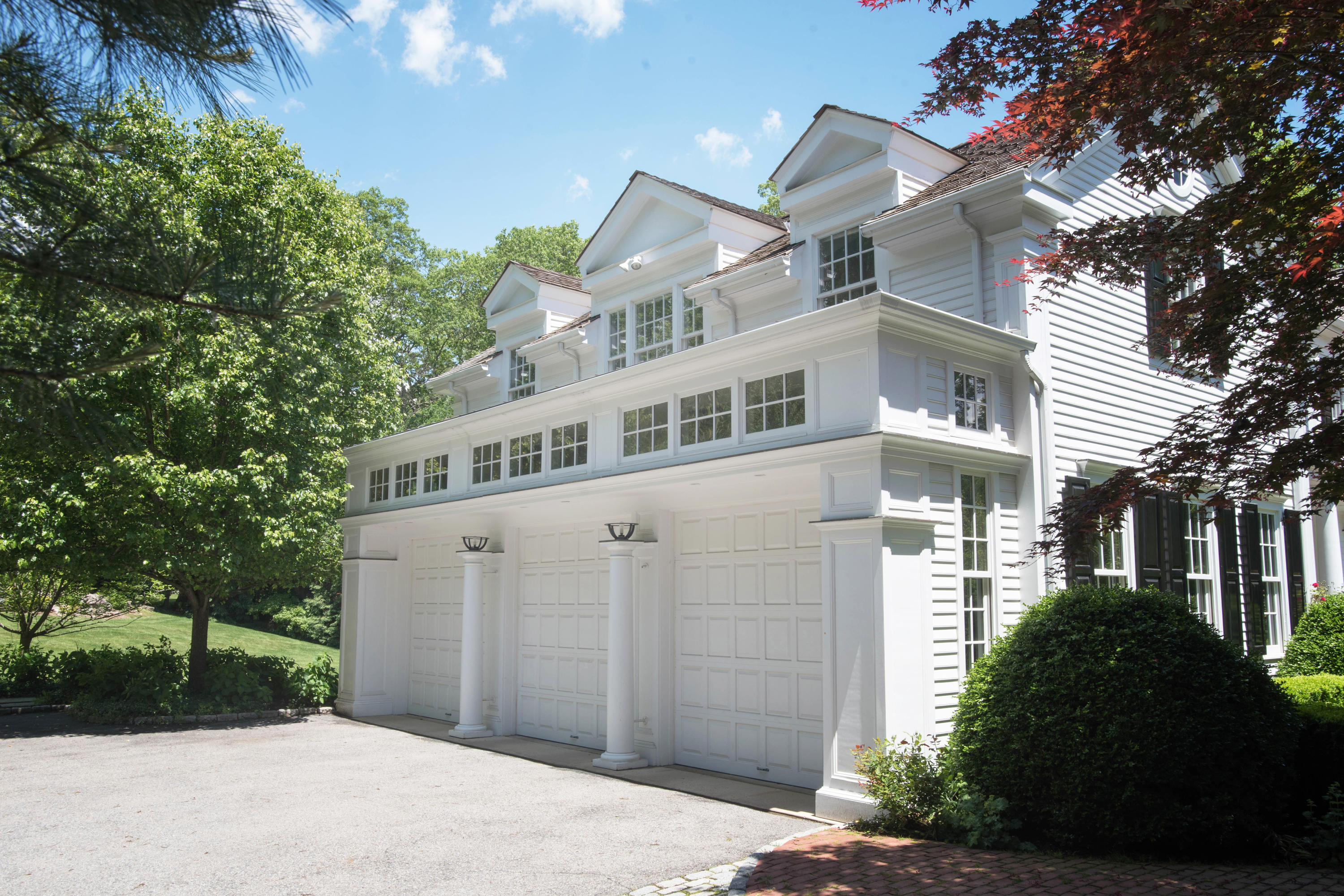 399 Wahackme Road New Canaan, CT 06840 - Photo 29 of 35 a front view of a house with a garden